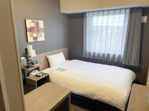Postel nebo postele na pokoji v ubytování Hotel Route-Inn Takefu Inter + 33 fotografií