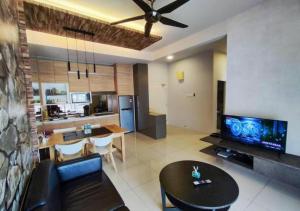 a living room with a couch and a table at Nature Home 3 - Swiss Garden Resort Residences in Kampung Sungai Karang