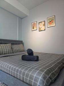 Ένα ή περισσότερα κρεβάτια σε δωμάτιο στο Cozy Retreat Homestay Kuala Terengganu