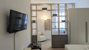 a living room with a flat screen tv on a wall at VivimiHome - Oasi Verona spazio comfort e relax in Verona
