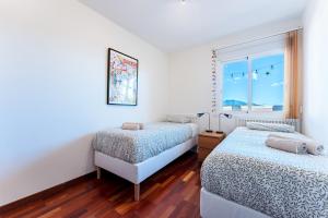 a bedroom with two beds and a window at Las Terrazas in La Cala de Mijas +15 photos