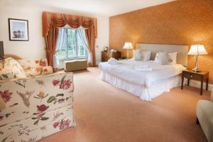 a hotel room with two beds and a couch at The Kings Head Country Hotel in Great Bircham
