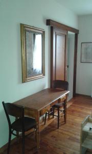 a dining room with a wooden table and a mirror at I Pioppi Bed & Breakfast in Chiari