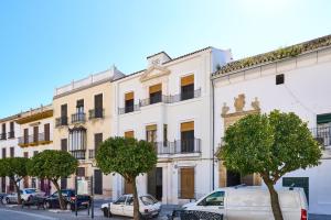a white building with cars parked in front of it at Casa Palacio Vida in Espejo