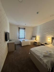 Ένα ή περισσότερα κρεβάτια σε δωμάτιο στο Macan Boutique Hotel by The ROOMZ
