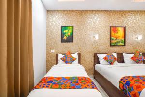 a bedroom with two beds in a room at Oriva Freshco in Bengaluru