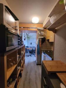 a kitchen with a counter and a table in it at Studio Colina 206 in Leysin