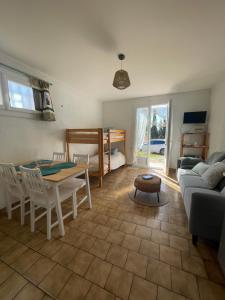 a living room with a table and a couch at Entre Mer et Vigne Caves in Caves
