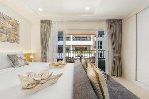 En eller flere senge i et værelse på The Terraza Lamai + 88 billeder