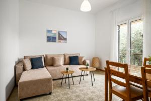 a living room with a couch and a table at The Island Life Apartments by Konnect, Ipsos Beach in Ipsos