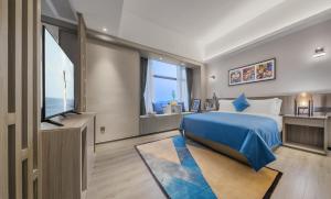 Postel nebo postele na pokoji v ubytování Foshan Shunde Ruitao Hotel