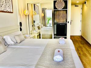 a bedroom with a bed with two pillows on it at Hotel Ankaa - Adults Only in Porto Cristo