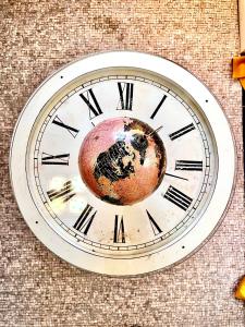 a clock on the side of a building at Sunny Suite by Leslodgespa - Studio moderne et coloré, proche de Bâle et de l'aéroport in Blotzheim