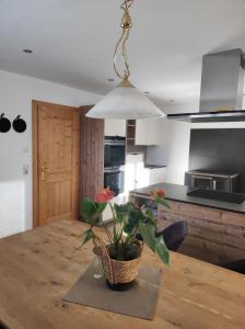 a kitchen with a table with a potted plant on it at Loiblgut in Maria Alm am Steinernen Meer +25 photos