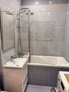 a bathroom with a tub and a sink and a shower at casa unica con vista sulla strada 12 in Caiazzo