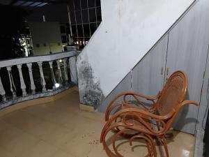 a wooden bench sitting in front of a staircase at Geeta Villa in Lucknow