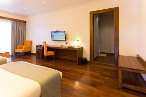 TV a/nebo společenská místnost v ubytování Hotel Grand Turf By GSP