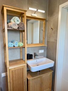 een badkamer met een wastafel, een spiegel en handdoeken bij Mc Home Neues und sonniges Doppelhaus, Top 1 mit grosse Terrasse und E-Ladestation in Dobl bei Graz in Dobl