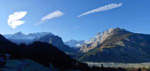 a view of a mountain range with snow covered mountains at Studio Eggi in Innertkirchen