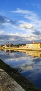 a large body of water with a building and buildings at La casa di Nana’ in Pisa