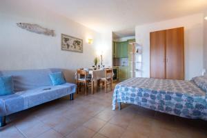 una camera da letto con un letto, un tavolo e un divano di CASA DEL MARINAIO a Porto Ottiolu