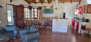 a kitchen and dining room with a table and chairs at Casa Luna Bca in El Mollar +22 photos
