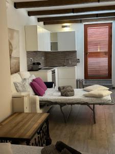 a room with a large bed in a kitchen at Greta's House Pizzo in Pizzo