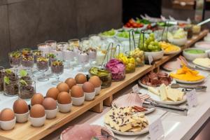 a buffet with eggs and other food on a table at Rise Urban Art Hotel in Larnaca