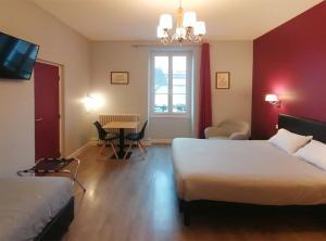 Postel nebo postele na pokoji v ubytování Hôtel Le Dormeux