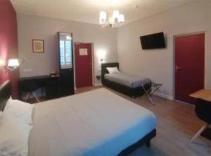 Postel nebo postele na pokoji v ubytování Hôtel Le Dormeux