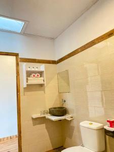 a bathroom with a toilet and a sink at Green Sunrise Hill View in Nusa Penida +24 photos