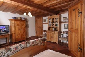 a living room with a couch and wooden furniture at Hotel und Gasthof Ritter St. Georg in Erlangen