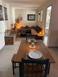 a living room with a table and a couch at chez Nadège in Floing +7 photos