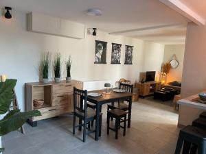 a dining room with a table and chairs in a room at chez Nadège in Floing