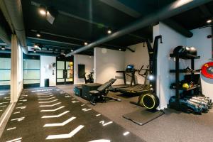 a gym with two treadmills and weights in a room at The Social Hub The Hague in The Hague