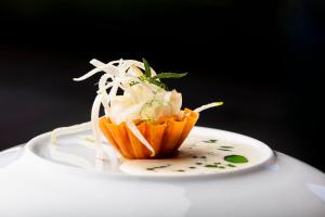 a cupcake with noodles on a plate on a table at Bella Vista Hôtel, Suites & Maisons in Porticcio