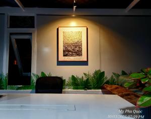 a room with a table and a picture on the wall at Mi Amor Ocean Penthouse - 3 minutes to the beach - Downtown in Phu Quoc