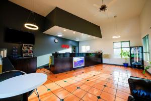 a large room with a table and a tv in it at OYO Hotel Hermiston OR, Downtown in Hermiston