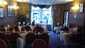 a dining room with tables and chairs and a clock at The Trafalgar in Blackpool