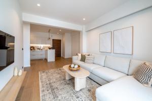 a living room with a white couch and a table at Serene in Tinos