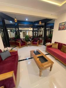 a living room with couches and a coffee table at Summit Embassy in Skardu