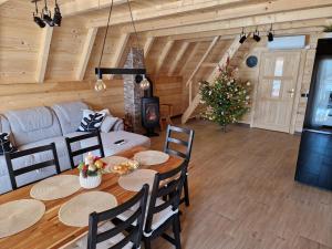 a living room with a table and a christmas tree at Planinska kuća za odmor Aneva in Sveti Rok