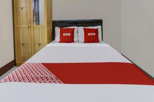 Postel nebo postele na pokoji v ubytování OYO 91137 Griya Cipu Syariah Guest House