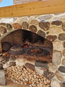a stone fireplace with a pizza in it at Planinska kuća za odmor Aneva in Sveti Rok