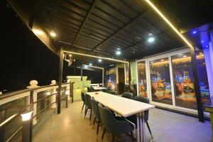 a restaurant with a table and chairs at night at Hotel Orion in Bhadrak