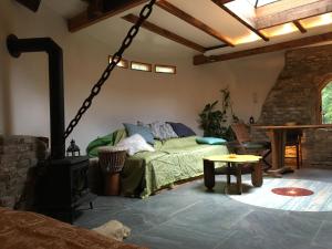 a living room with a bed and a wood stove at Ecostay de Wildernis in Wilp