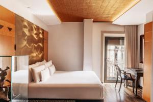 a hotel room with a bed and a piano at Claris Hotel & Spa GL, a Small Luxury Hotel of the World in Barcelona +37 photos