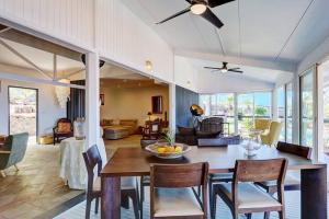 a dining room and living room with a table and chairs at Villa Vue-Belle in Saint-Paul