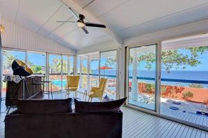 a living room with a couch and views of the ocean at Villa Vue-Belle in Saint-Paul