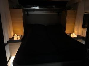 a dark room with a black bed in it at Romantische Wellness-Oase in Haasow +35 photos